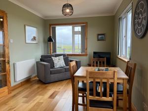 a living room with a table and a couch at The Homer in Kilmuir