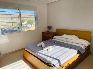 a bedroom with a large bed with a window at Casa Evie in El Campello +36 photos