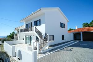 a white house with stairs in front of it at SEAING HOUSE in Falca