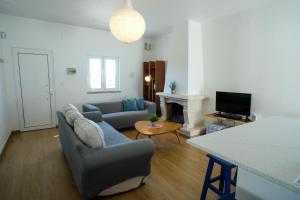 a living room with a couch and a fireplace at SEAING HOUSE in Falca