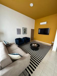 a living room with a couch and a flat screen tv at Casa di Marilena in Galatina