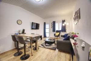 een woonkamer met een tafel en een bank bij Appart cosy Avignon intra-muros - WIFI TV Netflix in Avignon