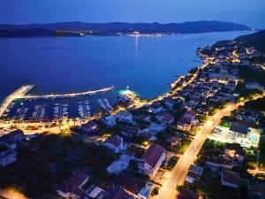 an aerial view of a city with a harbor at night at Sunny Day Luxury Holiday Apartments in Orebić