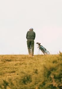 a man standing on top of a hill at Dornoch Station in Dornoch