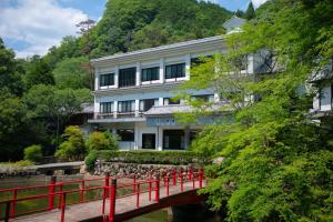 a building on a bridge over a river at Yumoto Ueyama Ryokan in Himeji