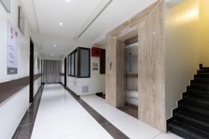 an empty hallway with stairs in a building at Sapphero Akshar Inn- Jamnagar in Jamnagar