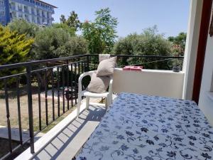 a balcony with a table and a chair on a balcony at Near the Ladies beach-100m only in Aydın