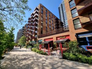 a street in front of a building with a restaurant at London Zone 1 House With Secure Garden in London