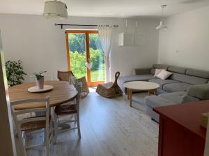 a living room with a table and a couch at Green place in Žetale +7 photos