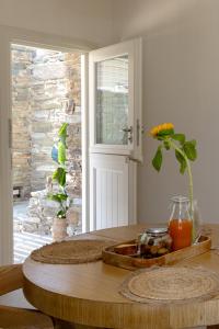 a table with a vase on it in a room at Velouchi Hideout Residence in Tinos
