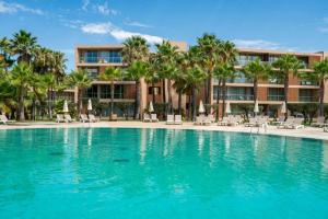 a swimming pool in front of a resort at Herdade dos Salgados Harmonia in Guia
