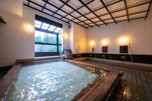 a large pool of water in a large room at Yumoto Ueyama Ryokan in Himeji