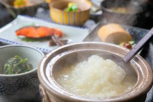 a bowl of sticky rice with a spoon in it at Yumoto Ueyama Ryokan in Himeji