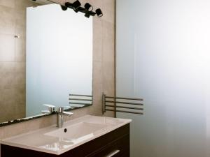 a bathroom with a sink and a large mirror at Villa KM2 lovely villa located just outside of Sa Carroca a 5 minute drive from Playa den Bossa in Sant Josep de sa Talaia