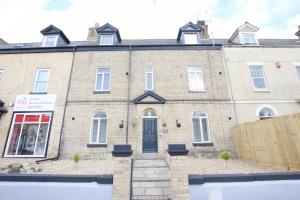 a large brick house with a black door at Stylish City Centre Apartments in Lincolnshire