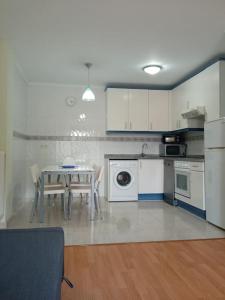 a kitchen with a table and a dining room at Apartamento LEILA in Posada de Llanes