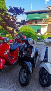 a group of scooters parked in a parking lot at Hotel Virginia in Garda