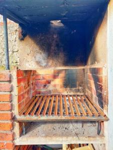 a brick oven with a fire inside of it at La casa de fabian in Mar del Plata +13 photos