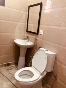 a bathroom with a toilet and a sink at Zoeys Homestay - 1BHK with Free Breakfast in Jammu