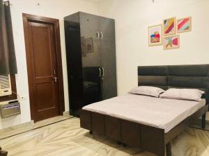 a bedroom with a bed in a room at Zoeys Homestay - 1BHK with Free Breakfast in Jammu