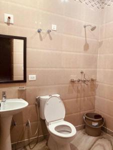 a bathroom with a toilet and a sink at Zoeys Homestay - 1BHK with Free Breakfast in Jammu