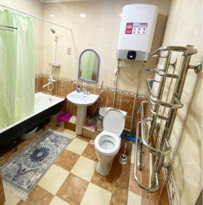 a bathroom with a toilet and a sink at Уютные апартаменты 5 микрорайон in Aktau