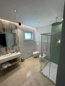 a bathroom with a glass shower and a toilet at Villaggio Marco Polo in Santa Domenica