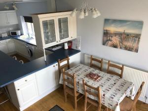 a kitchen with a table and a table and chairs at The Oasis Hotel in Llandudno