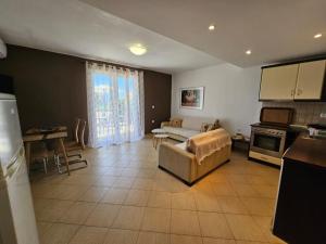 a living room with a couch and a kitchen at Corfu Glyfada Beach Apartment 22 in Glyfada