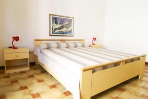 Un pat sau paturi într-o cameră la Alghero- Lungomare Via Lido Cozy Flat W/Parking!