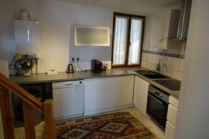 a kitchen with white cabinets and a counter top at Colmar charmant logement in Colmar