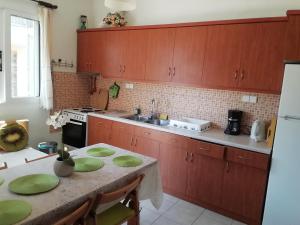 a kitchen with a table with green plates on it at Aristoula House in Sivota +34 photos