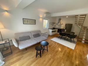 salon z kanapą oraz stołami i krzesłami w obiekcie Apartments Mali Ivo w Nin