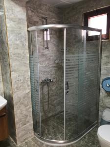 a shower with a glass door in a bathroom at Danis Otel Ve Restoran in Uzungol +67 photos