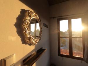 a mirror on a wall next to a window at Rhodes Youth Hostel in Rhodes Town