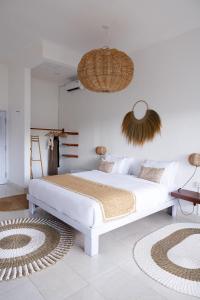 biała sypialnia z dużym łóżkiem w pokoju w obiekcie Bella Bali w mieście Uluwatu