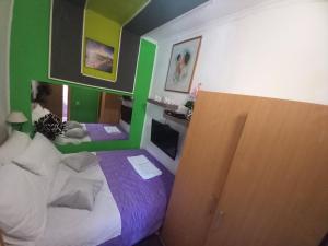a room with a bed with a green wall at S Type Apartment in Split