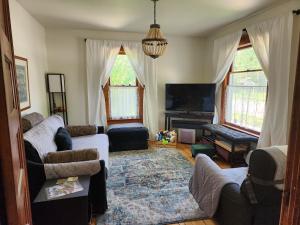 a living room with two couches and a tv at The Landerholm Bed and Breakfast in Wisconsin Rapids