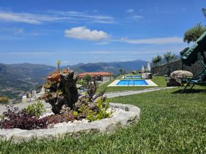 a garden with a swimming pool in a yard at Casa do Iteiro in Caniçada