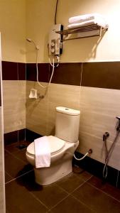 a bathroom with a toilet and a shower at Crescendo Boutique Hotel in Nusajaya