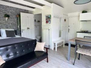 a bedroom with a bed and a table in it at Coast Holiday Appartements in Dirkshorn