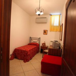a bedroom with a bed and a table and a window at Hotel Savoia in Sapri