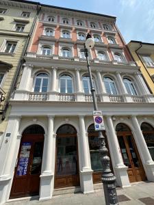 a building with a street light in front of it at App Borsa Trieste in Trieste