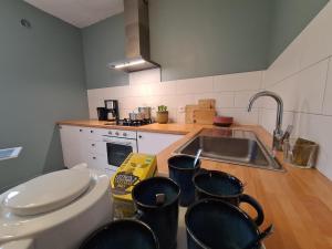 a kitchen with a sink and some pots and pans at Gîte LE MAGE - maison de retrouvailles in Saint-Marcel