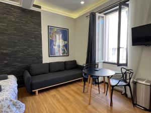 a living room with a couch and a table at Newly Renovated Suite in the Center of Cannes in Cannes