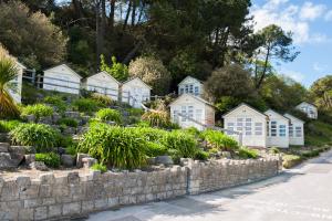 a row of houses next to a stone wall at The Canford in Poole