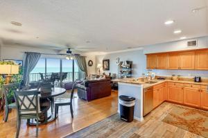 a kitchen and living room with a table and a couch at Oceanside 302 in Clearwater Beach