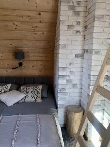 a room with a bed in a wooden cabin at RELAS - przytulny domek z dwoma sypialniami i antresolą in Murzasichle