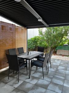 a wooden table and chairs on a patio at Apartma Šmit Premium in Vir