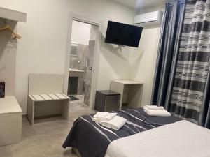 Posteľ alebo postele v izbe v ubytovaní Akoya Rooms Capo Vaticano